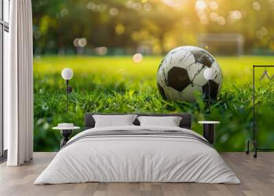 Soccer ball on lush green grass with bokeh background   sports concept in realistic photo Wall mural