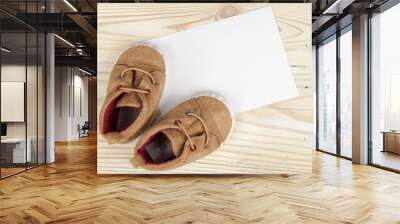 pair of baby shoes on wooden table Wall mural