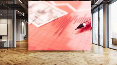 Finance background with money, stock market chart, graph and pen. Living coral toned. Wall mural