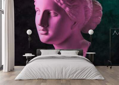 Gypsum copy of ancient statue Venus head on a dark green textured background. Plaster sculpture woman face. Wall mural