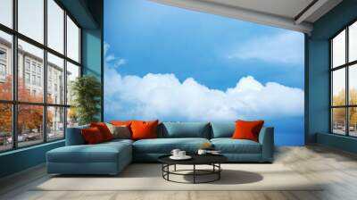 Natural sky composition. Sunny vast blue sky abstract background. Beautiful cloudscape, view over white fluffy clouds. Freedom concept, on the heaven. Element of design. Wall mural