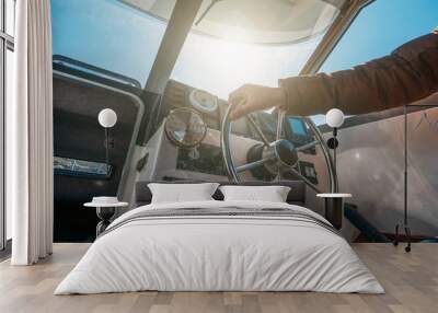 Boat or yacht captain hand on boat steering wheel and sea navigation system Wall mural