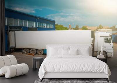 Cargo truck in industrial warehouse or logistic center waiting for loading goods Wall mural