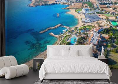 Cyprus landscape. Aerial panoramic view of bay with sandy beach and hotel on coastline, drone photo. Mediterranean vacation and travel concept. Wall mural