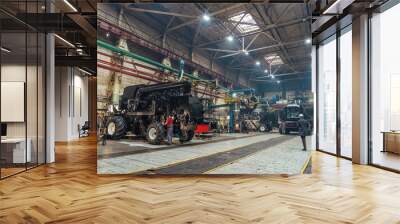 Factory hangar with combine harvesters assembled. Industrial production of agricultural machinery. Wall mural