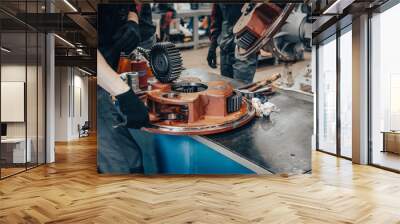 Mechanic worker hands assembly spare part of agricultural machine at factory, close up. Wall mural