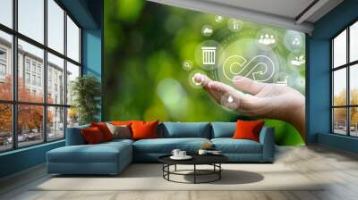 circular economy symbol on hand icon with an endless circular economy in the concept of sustainable business and environmental growth in the future Wall mural