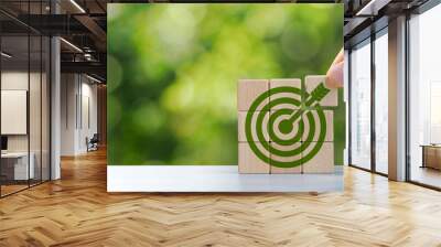 Environmental goals of green business Business development strategy with sustainable environmental conservation wooden block on handle With a green target icon. copy space Wall mural