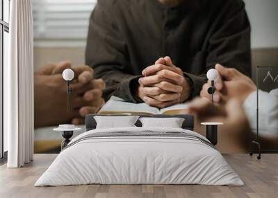 Ideas for praying to God in the home as a team Young men sitting and praying together Ready to pray to God with the Bible asking for forgiveness and faith. Wall mural