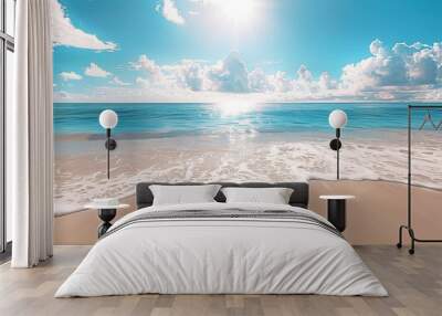 A beautiful sandy beach with waves gently lapping at the shore under a clear blue sky  Wall mural