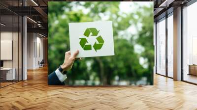 Businessman holding a sign recycle reuse reduce on nature background for zero waste concept and environmental sustainability. CSR corporate social responsibility. eco friendly design product Wall mural