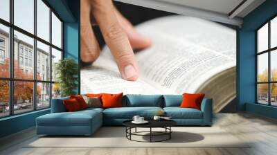 Close-up of man's hands while studying the Bible. Wall mural