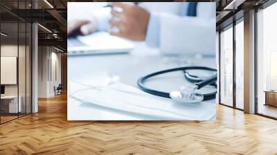 Doctor working on laptop computer and medical stethoscope on clipboard on the desk. Medic tech, telehealth, online medical, teleconference, or telemedicine concept. Wall mural