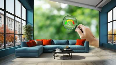 hand holding a magnifying glass to check the  good air quality and clean outdoor air quality safe from pollution dust PM 2.5 Wall mural