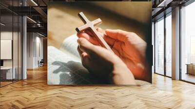 Man Pray for god blessing to wishing have a better life. man hands praying to god with the bible and cross. believe in goodness. Holding hands in prayer on a wooden table. Wall mural