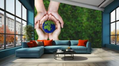 many hands person holding the earth on a green background to protect nature save and care world for  Wall mural