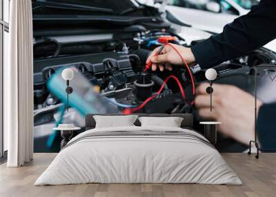 Technician Hands of car mechanic working repair in auto repair Service electric battery and Maintenance of car battery. Check the electrical system inside the car. Wall mural