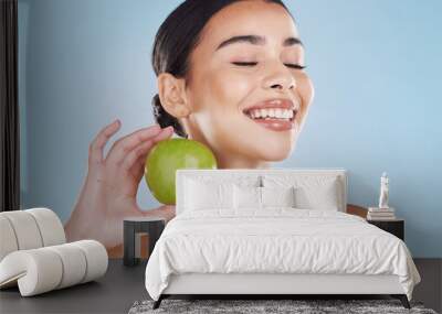 Health, skincare and beauty woman with an apple for wellness, healthy and organic lifestyle in studio. Girl with clear, fresh and natural skin holding a fruit with vitamins and nutrition for a diet Wall mural