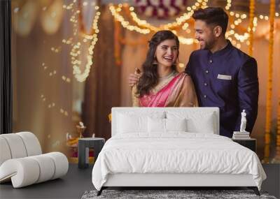 Happy Diwali, happy Indian couple  holding diya, celebrating Diwali, the festival of lights. Wall mural