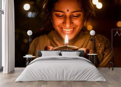 Happy Diwali, Portrait Indian woman smiling and holding a lit diya (oil lamp) in both hands, celebrating Diwali, the festival of lights Wall mural