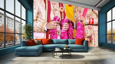 The bride and groom at the Indian wedding garlands or Jaimala ceremony Wall mural