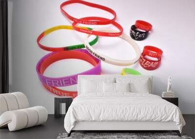 Different types of circular friendship wrist bands and friendship rings on white background for friendship day Wall mural