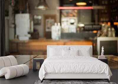 Empty old wood table top with bokeh coffee shop interior background. Wall mural