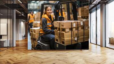 A woman moving pallet with a forklift in a warehouse. Female drive forklift in a big factory. Wall mural