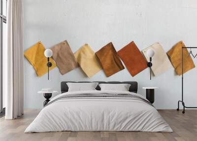 brown suede leather cowhide swatches on white wall, copy space Wall mural