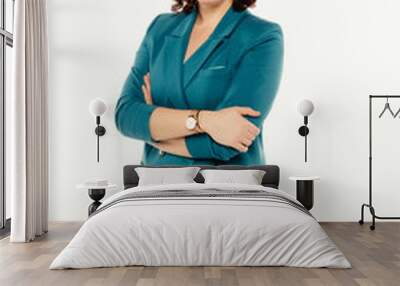 Portrait of smiling attractive businesswoman in blue suit posing while standing with arms crossed and looking at camera isolated over white background. Wall mural