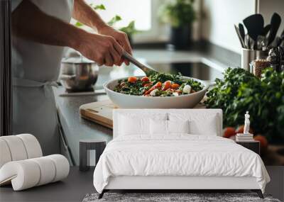 Chef preparing a healthy salad with fresh ingredients in a modern kitchen with vibrant greens and vegetables Wall mural