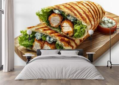 A grilled wrap with chicken, lettuce, and blue cheese dressing on a wooden board. Wall mural