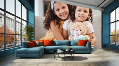 Family, children hug and portrait of girls on sofa in living room while holding teddy bear. Love, care and happy kids, sisters and siblings bonding, embrace and hugging on couch in lounge of house. Wall mural