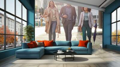 Business people in city, walking and travel with commute to work, happy corporate group with journey and outdoor. Professional, businessman and women walk in street with employees traveling together Wall mural