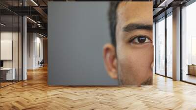 Mockup, portrait and half eyes of a man isolated on a grey background in studio. Serious, Asian and closeup face of a person with space for expression, looking handsome and a young eye on a backdrop Wall mural