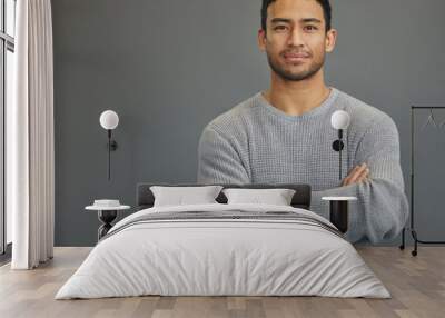 Portrait of man in studio with mockup space, arms crossed and confident smile on studio backdrop in casual fashion. Relax, confidence and face of male on grey background with focus, pride and mock up Wall mural