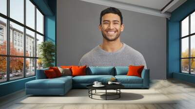 Portrait of man in studio with smile, happy mindset on studio backdrop in Indonesia and casual fashion. Relax, confidence and natural face of calm Asian male model on grey background with happiness. Wall mural