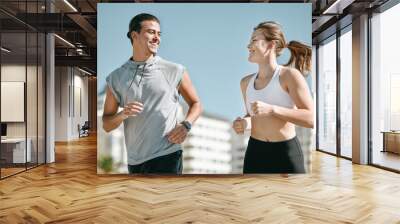 Couple, fitness and smile running in the city for exercise, workout or cardio routine together in Cape Town. Happy man and woman runner taking a walk or jog for healthy wellness or exercising outside Wall mural