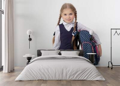 little schoolgirl  in school uniform on a white background Wall mural