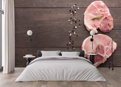 Top view raw pork chop steak and salt, pepper on wooden backgrou Wall mural