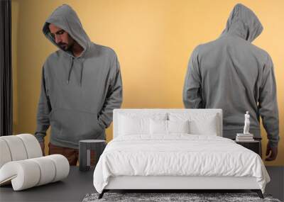 Front and back view of a grey hoodie mockup for design print on yellow background. Wall mural