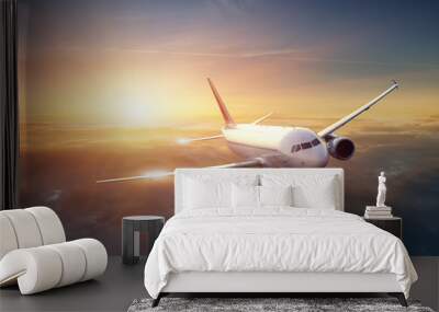 Airplane in the sky at sunset Wall mural