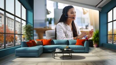 Eager to assist. Shot of a female agent working in a call centre. Wall mural