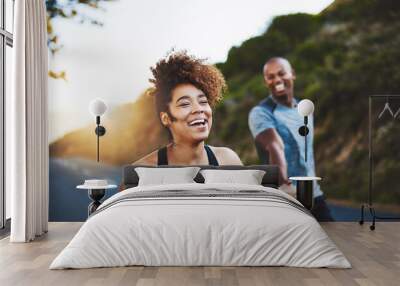 Exercising will only make you feel better. Cropped shot of a happy young couple out for a run together. Wall mural