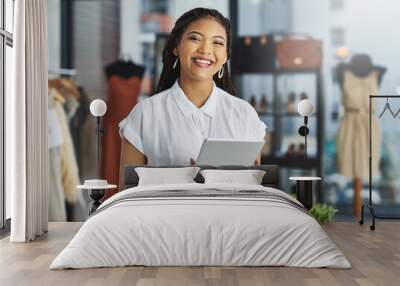 Few things satisfy me like working for myself. Cropped portrait of a young business owner using her tablet while standing in her store. Wall mural