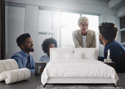 Its lovely to meet you. Cropped shot of a diverse group of businesspeople having a meeting in the office and shaking hands. Wall mural