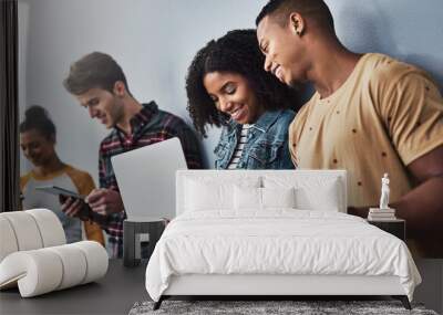 Keep sharing that connection. Studio shot of a group of young people using wireless technology against a gray background. Wall mural