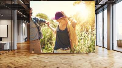 On an awesome outdoor adventure. Shot of a happy young couple exploring nature together. Wall mural