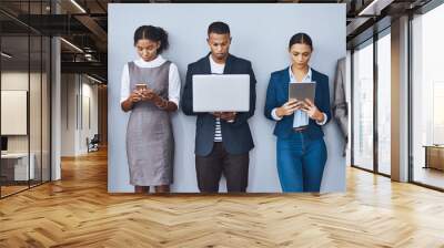 Standing in line. Cropped shot of a group of young businesspeople waiting in line for their interviews. Wall mural