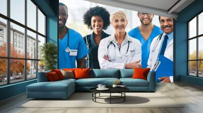 Team or group of a doctor, nurse and medical professional colleagues or coworkers standing in a hospital together. Portrait of diverse healthcare workers looking confident and happy about medicine Wall mural